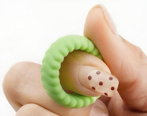 Silicone ring with a textured design worn on a finger against a white background