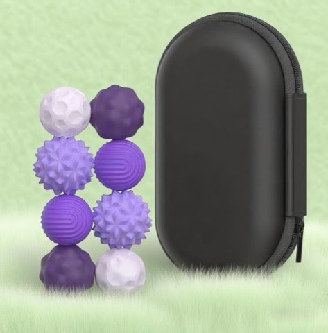 Set of purple and white textured balls with a black carrying case on a light green background